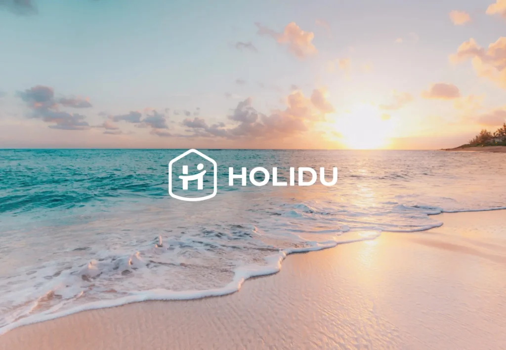 Holidu logo over a sunset beach scene for vacation rental and travel technology services