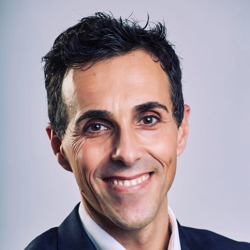 Professional close-up portrait of an alfonso lacerda in a dark suit.