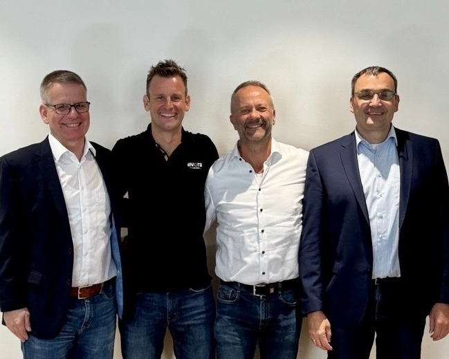 Evora IT Solutions leadership team standing together during a business meeting, representing executive collaboration and digital transformation consulting.